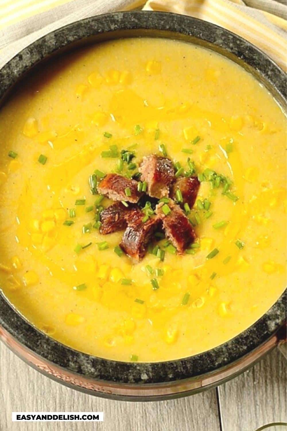 easy corn chowder in a pot with some garnishes on top