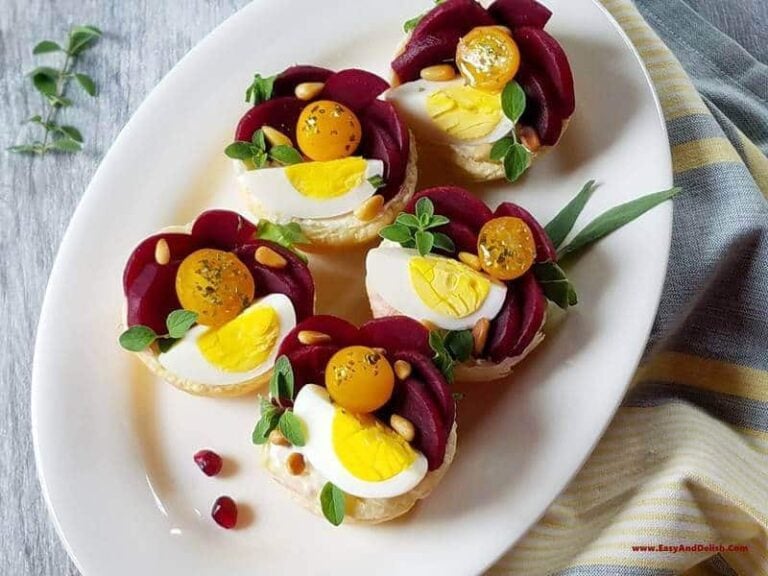 A plate with puffy pastry tartlets garnished for the holidays