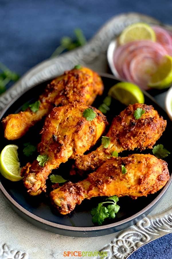 Tandoori chicken Drumsticks in a platterto serve as one of those easy chicken dishes that you can make with drumsticks by Spicy Cravings