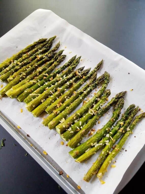 roasted asparagus on a lined sheet pan