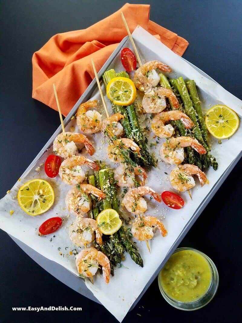 one pan with skewers of shrimp and asparagus