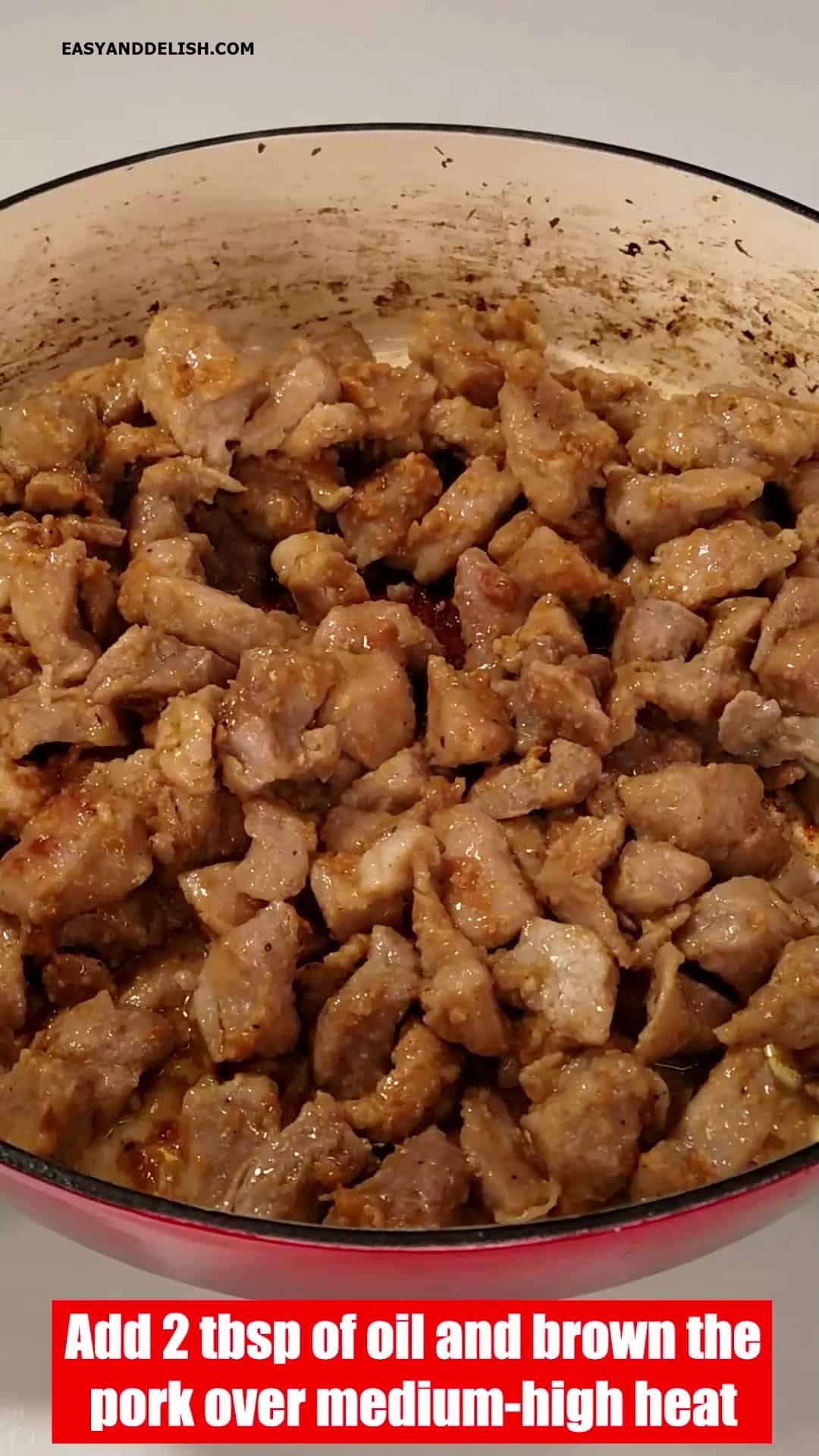 Browning the pork mixture in a pan. 