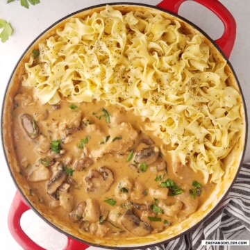 A large pan of pork stroganoff with egg noodles.