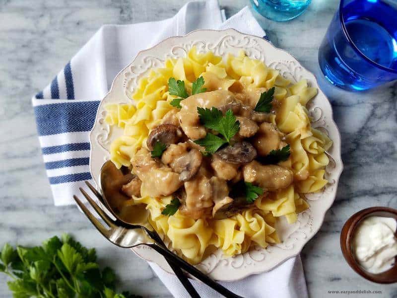 slow cooker pork stroganoff over egg noodles in a plate 