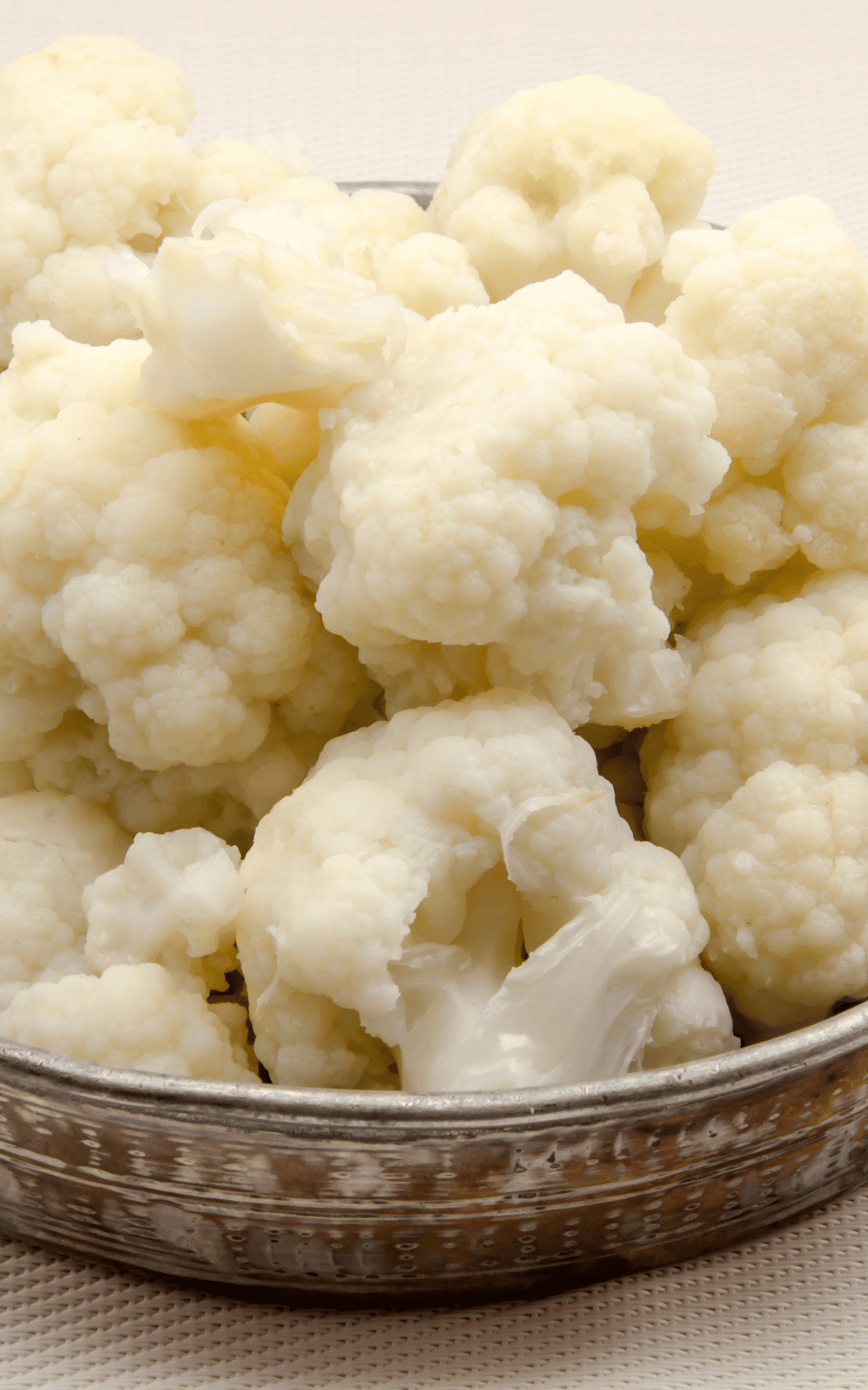 cooked cauliflower florets in a bowl.