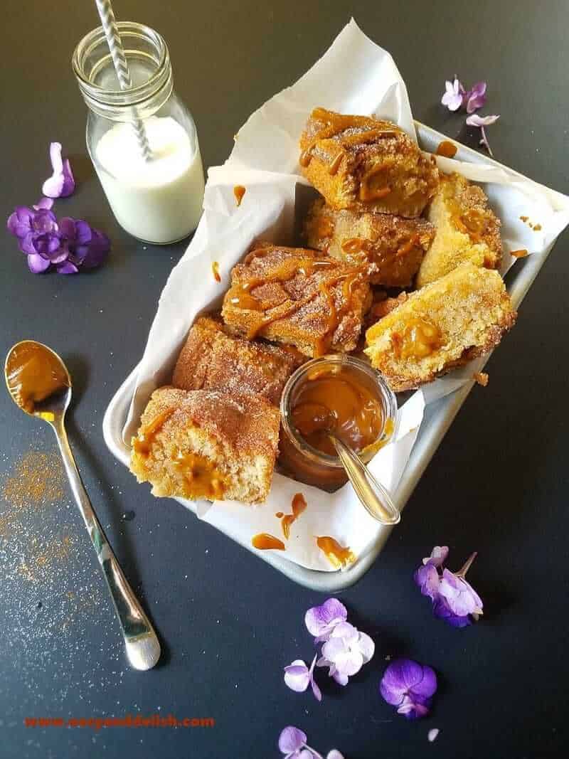 A plate of cake squares with a fork and knife