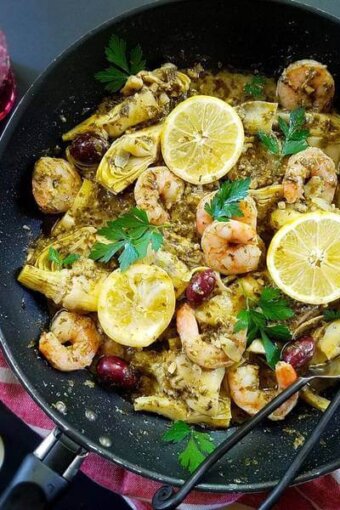 A bowl of seafood and lemon slices