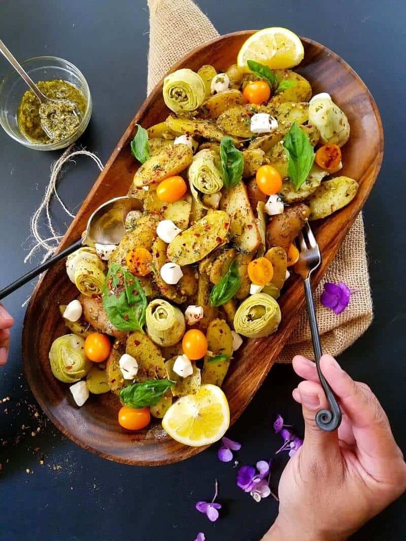 healthy potato salad in a platter with silverware on the sides.