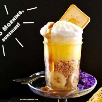 A cup of pudding with a cookie on top