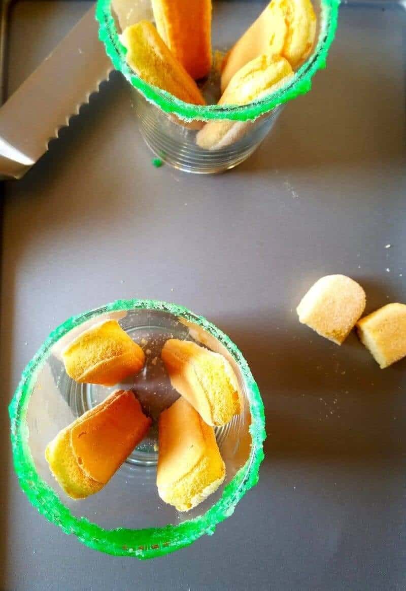 showing the layering of coconut tiramisu in a  glass