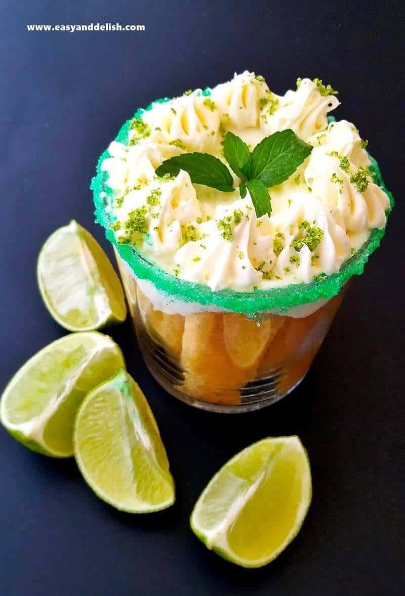 close up of coconut tiramisu in a glass with lime wedges