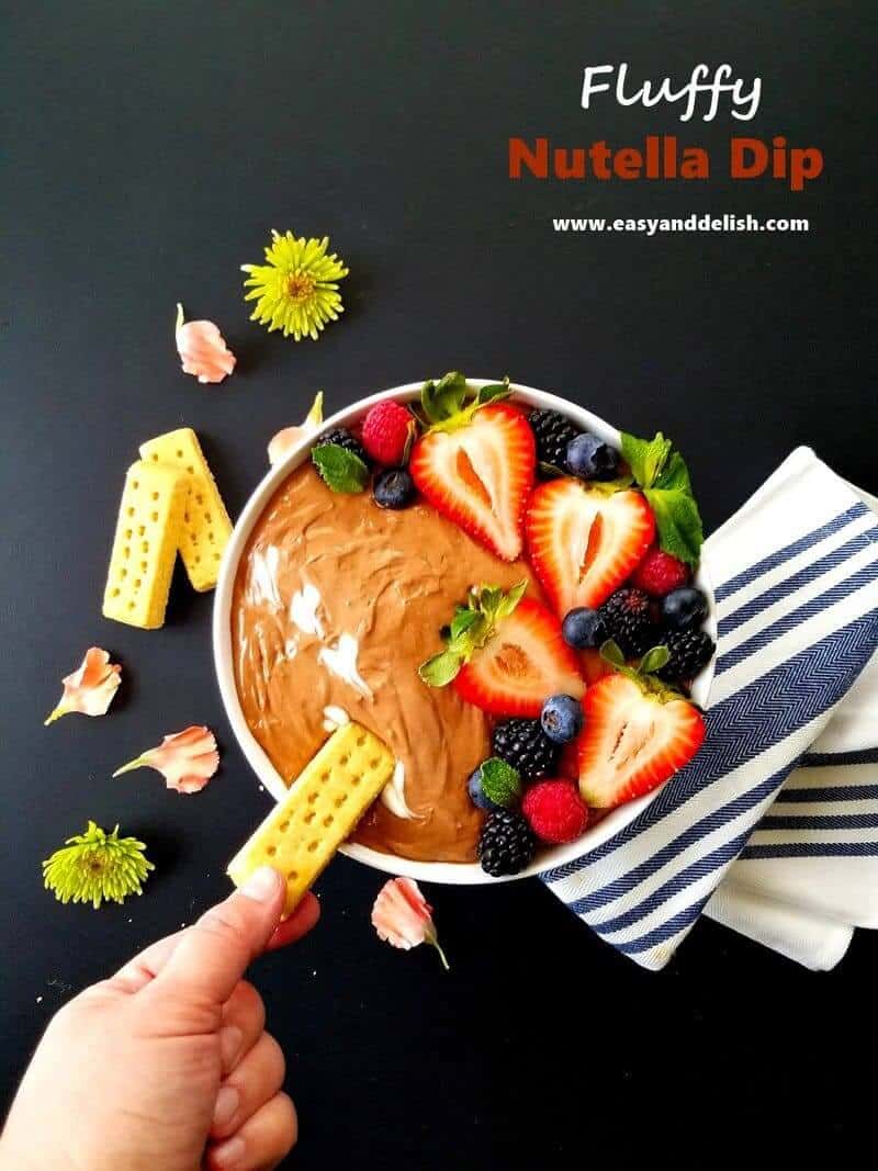 dipping a cookie in a bowl of Nutella dip