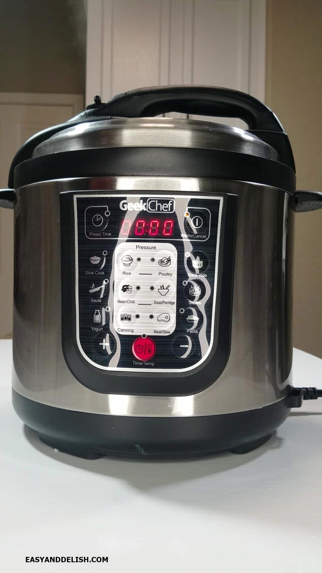 Cooked ingredients in the pressure cooker with pressure being released.