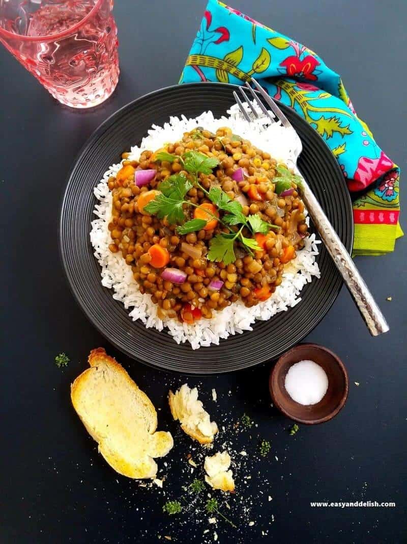 lentil coconut soup in a plate with rice and also toast on the side