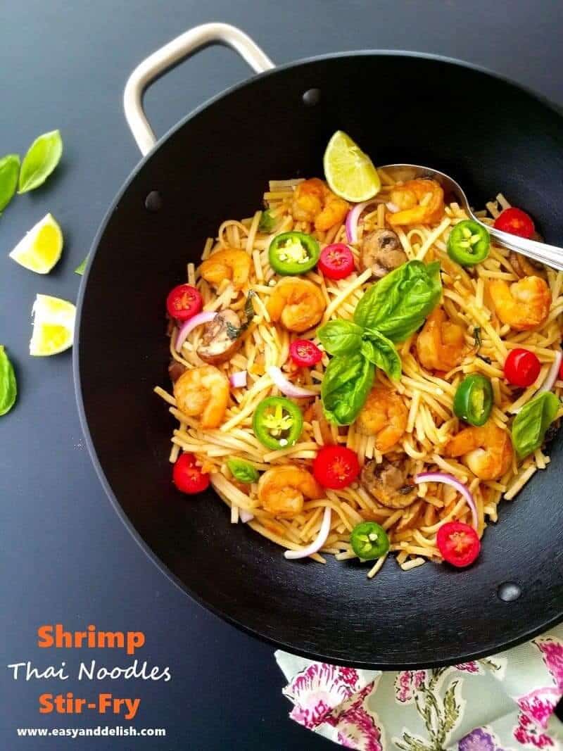 shrimp thai noodles stir fry in a wok pan