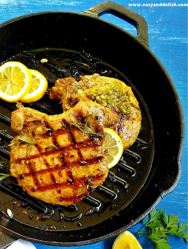 close up of grilled pork chops with lemon slices
