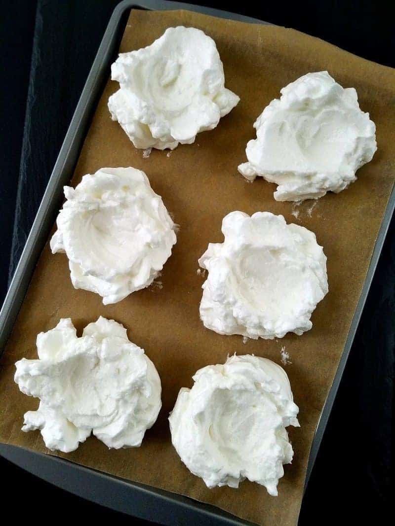 meringues on a baking sheet before being baked