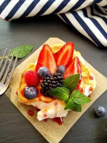 berry cloud eggs over a square of parchment paper