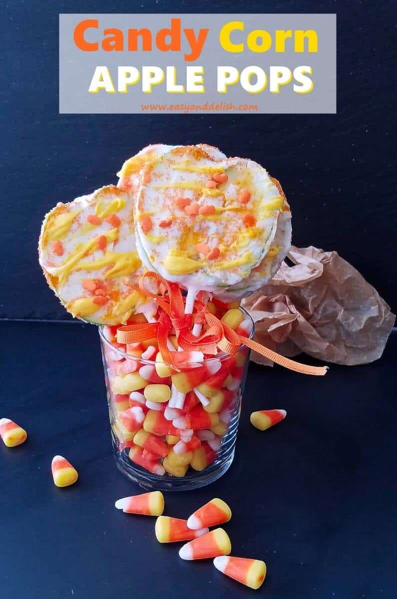 apple pops in a cup filled with candy corn