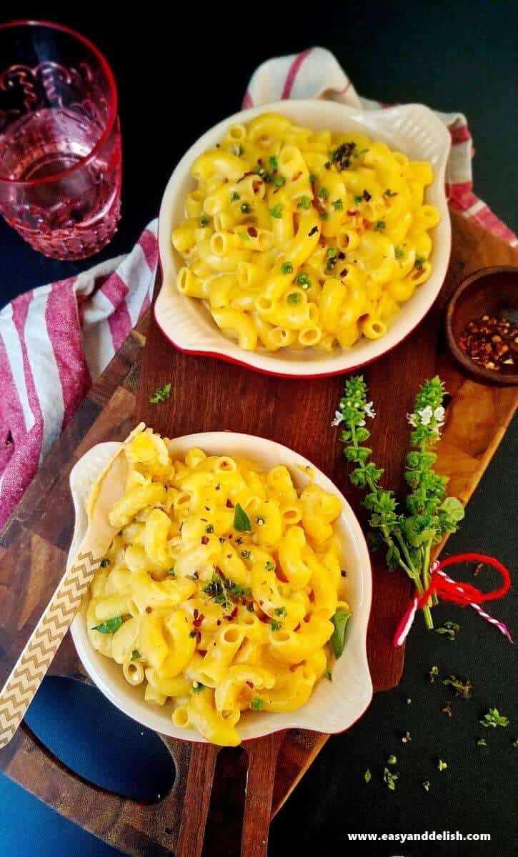 two bowls of mac and cheese with a glass of water on the side for our 35 pantry recipes