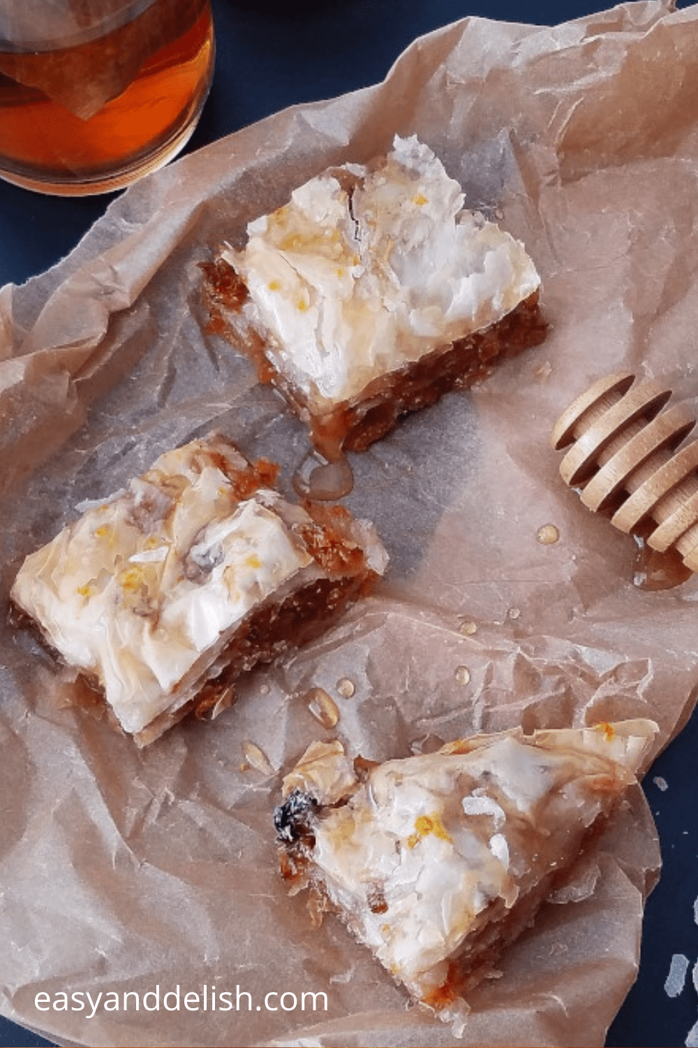 squares of a sweet treat over parchment paper drizzled with syrup