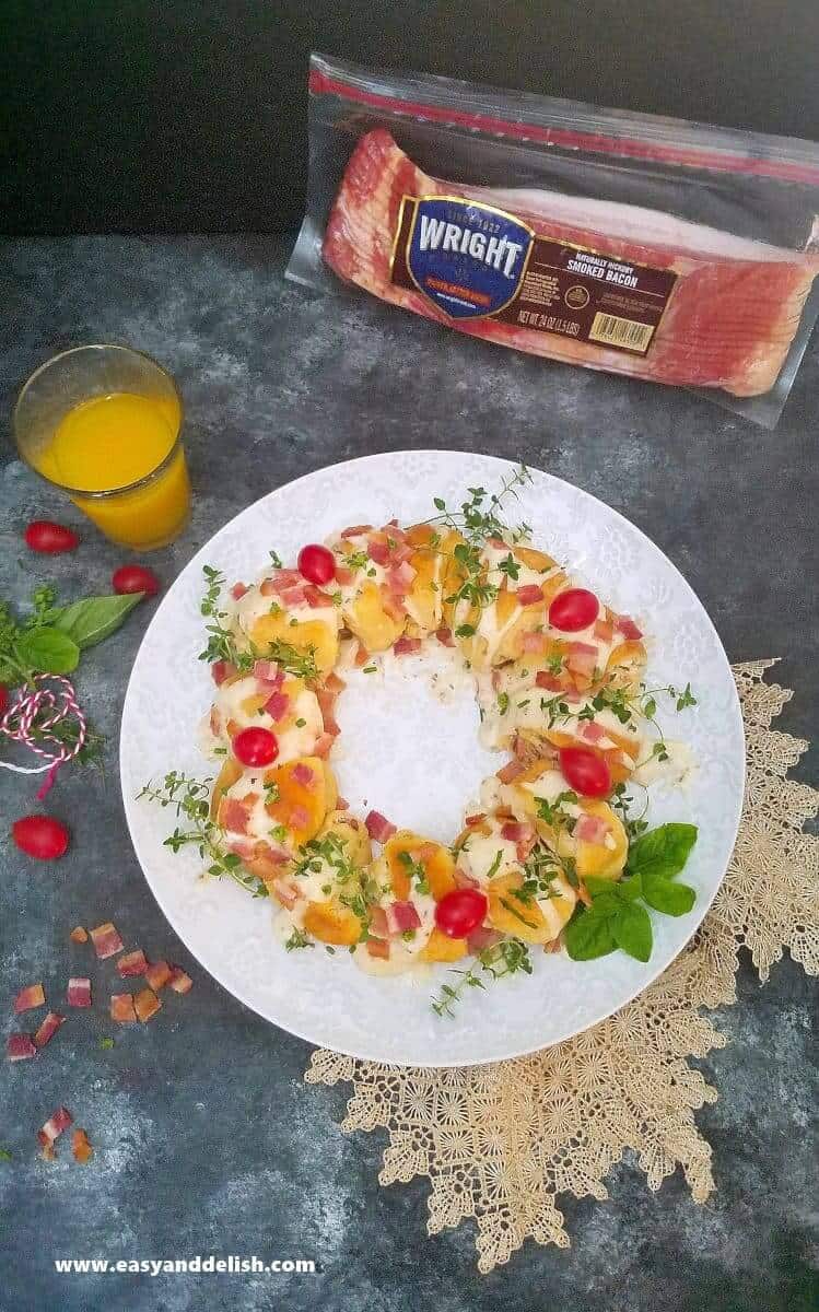 breakfast ring with a glass of juice on the side and a bag of bacon on the background 
