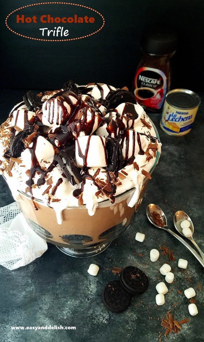 chocolate trifle topped with marshmallows and drizzled with chocolate sauce with ingredients on the side