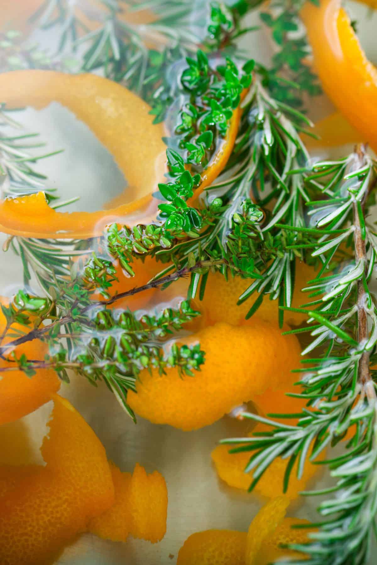 Close up of a mixture of salt, water, sugar, and aromatics in a pot. 