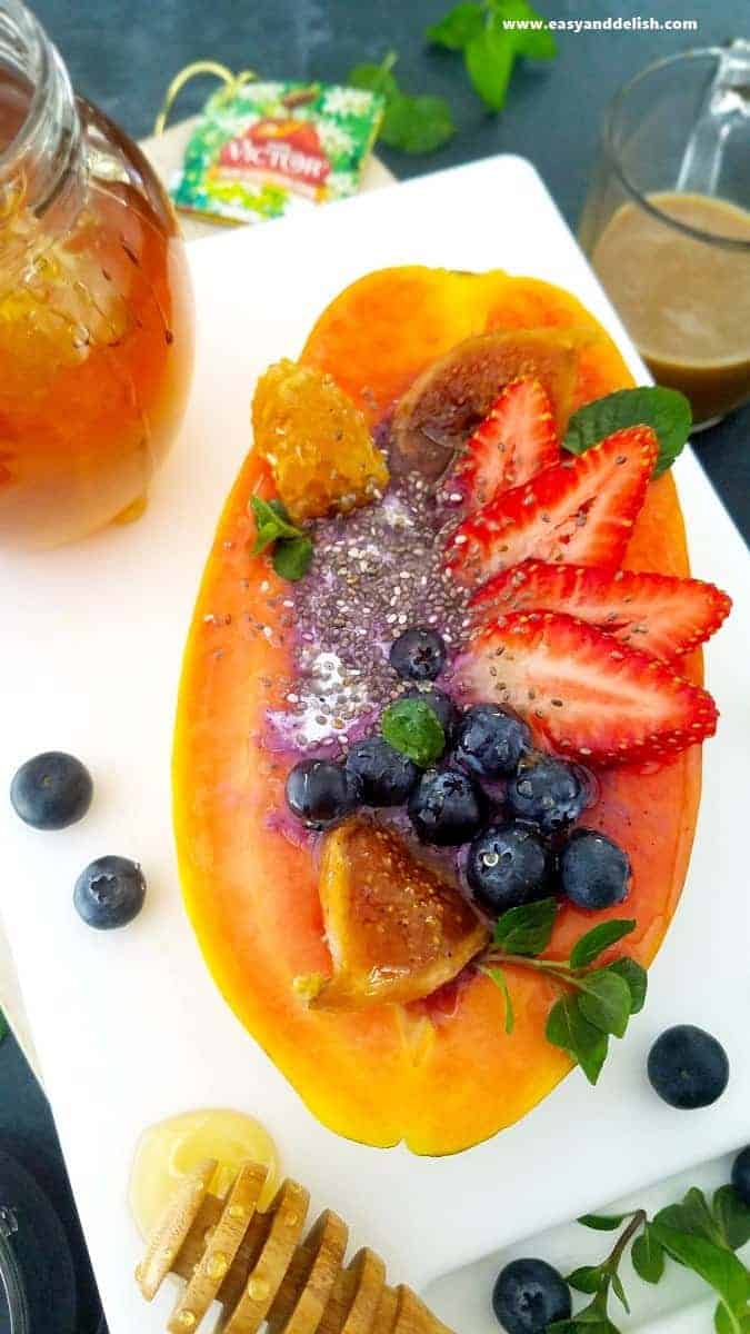 A plate with a blueberry smoothie in papaya boat (close up)