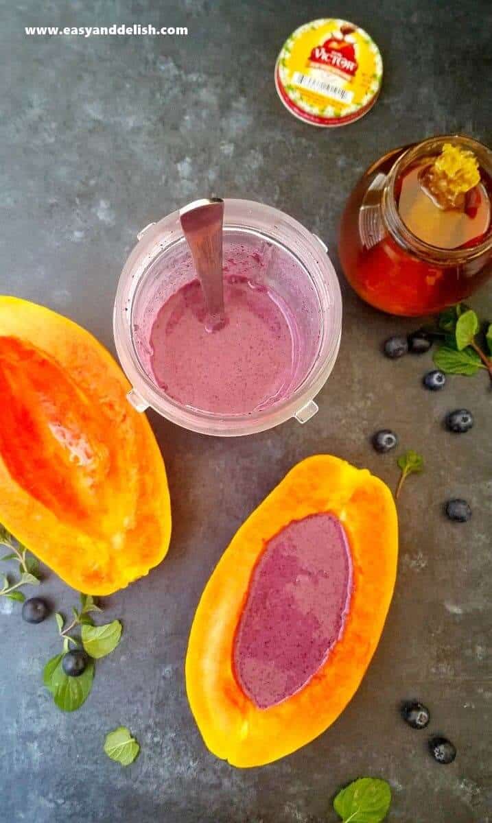 papaya halves a cup of smoothie plus a har of honey