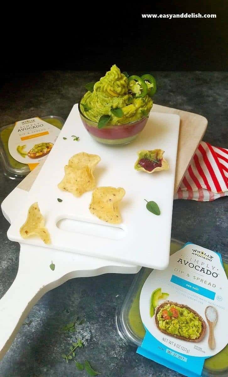 A tray of chips with a bowl of the dip 