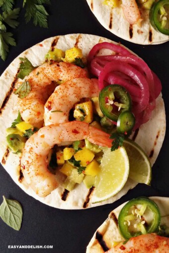 spicy shrimp tacos with flour tortillas and sides