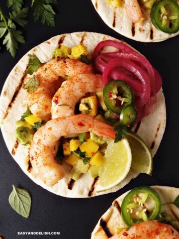 spicy shrimp tacos with flour tortillas and sides