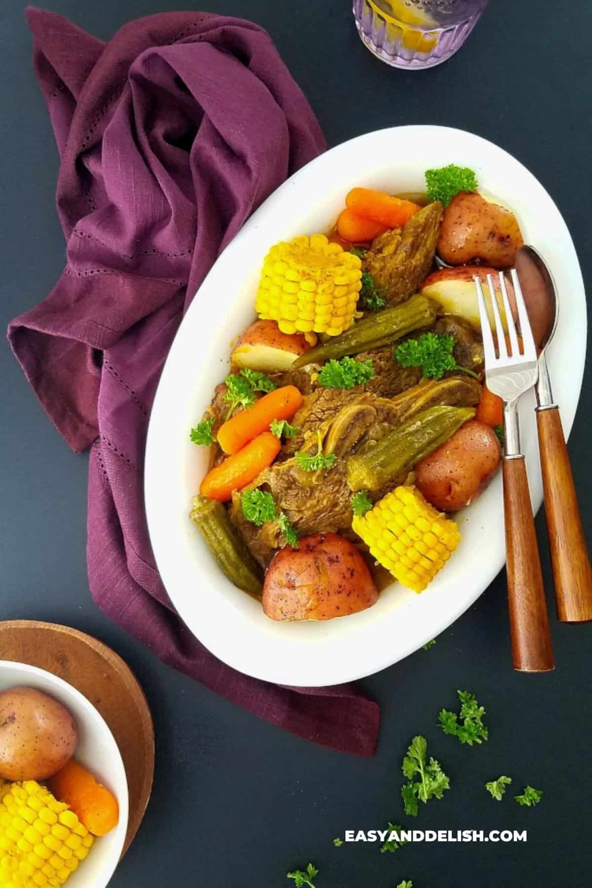 instant pot beef short ribs with vegetables and cutlery on the side