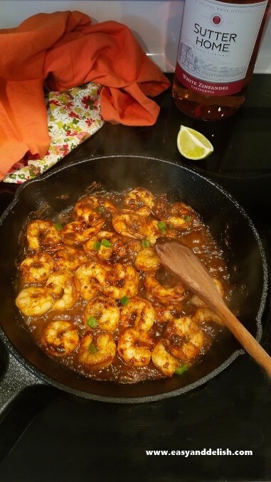 Shrimp being cooked in a skillet on stovetop