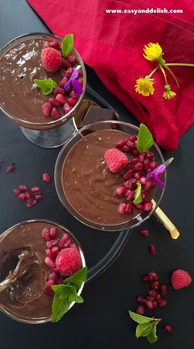 Overhead view of 3 cups of vegan chocolate pot de creme on a platter.