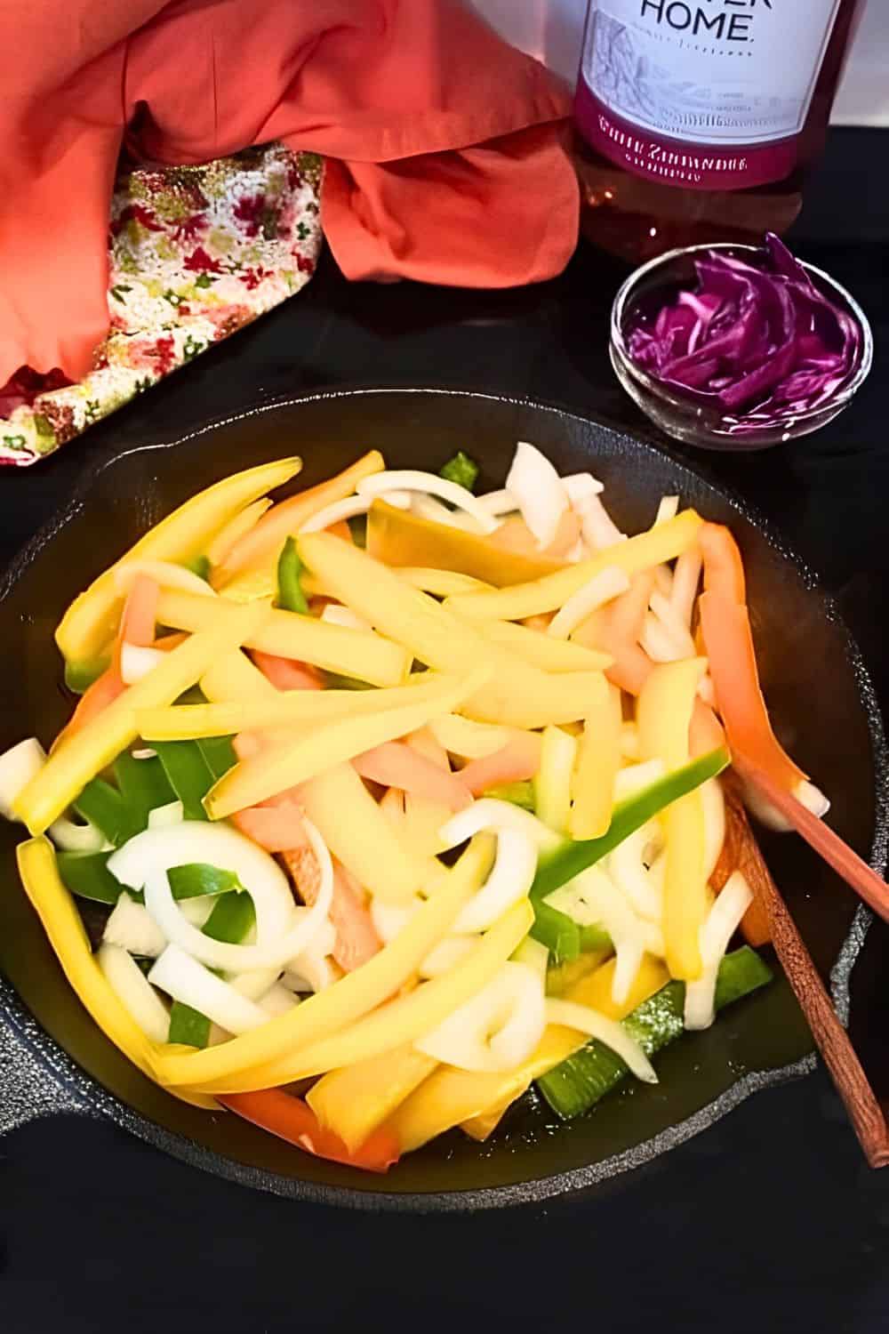 Vegetables being cooked in a skillet on stovetop.