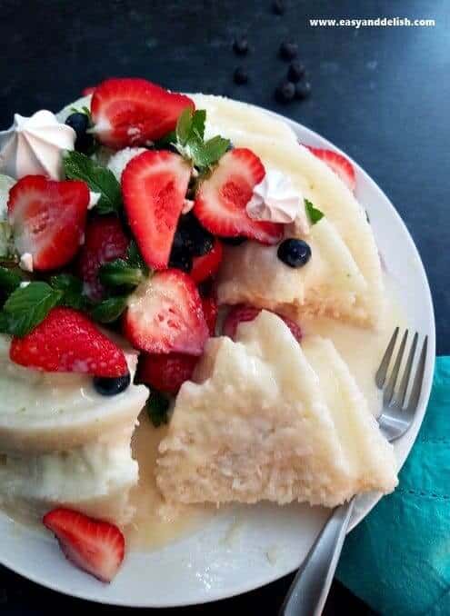 Sliced No Bake Tapioca Cake topped with berries