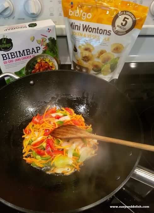 vegetables being stir-fried in a won