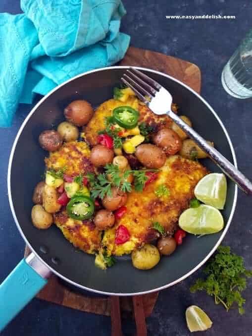 Turmeric lime chicken served on a table with a drink on the side