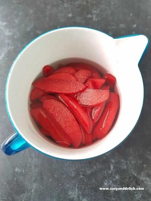 Colored apples in a pitcher 