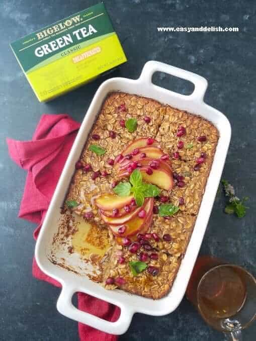 apple baked oatmeal ina baking dish with a box of tea on the side 