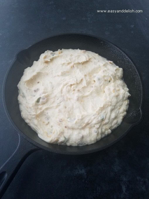 potato mixture for loaded mashed potato skillet right before being baked in a cast iron skillet