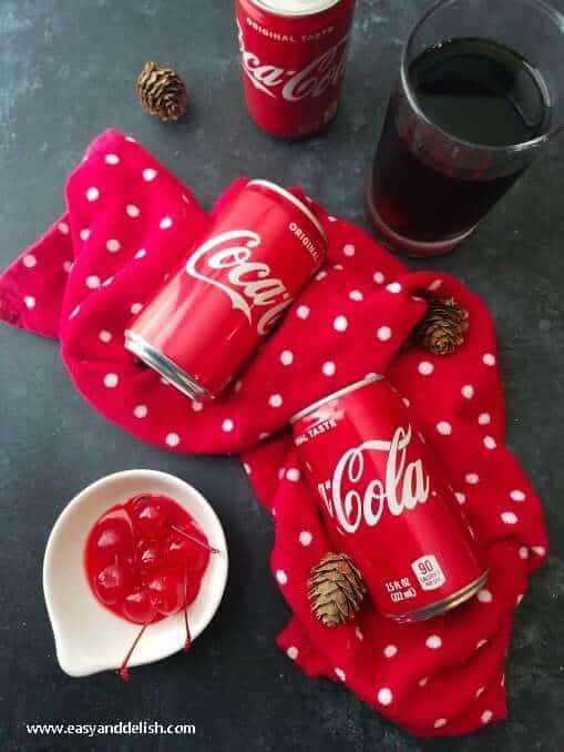 Roy Rogers Mocktail with Coca-Cola cans displayed on a table