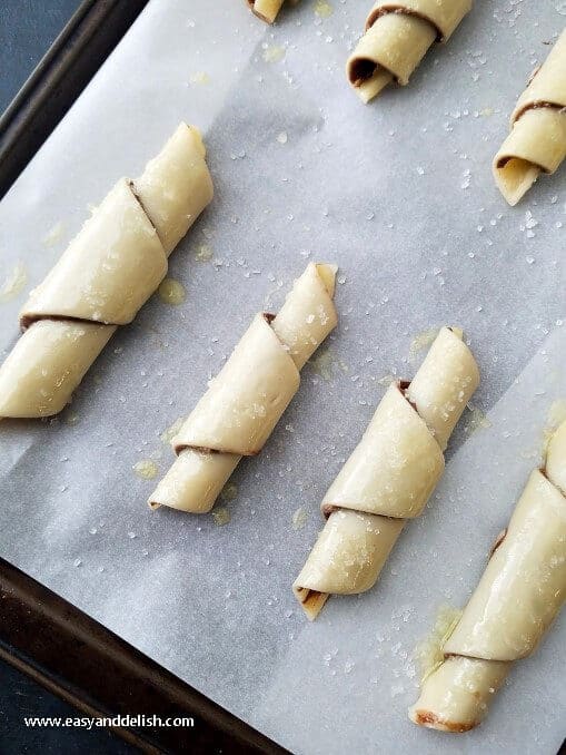 Chocolate Hazelnut Spread cookie roll ups on a lined baking sheet right before baking