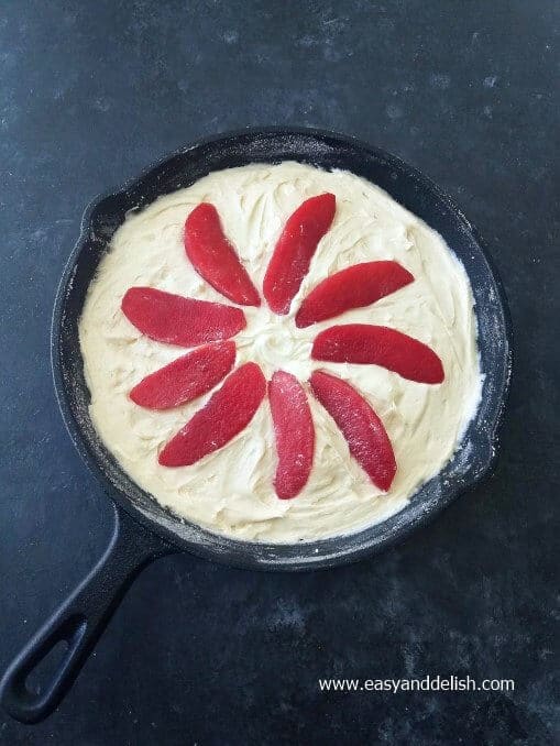 batter and apple slices assembled in a skillet right before baking