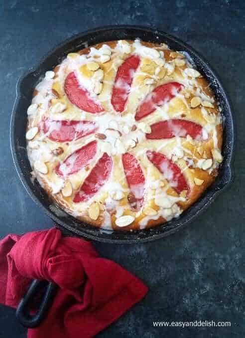 A skillet of almond cake with a napkin