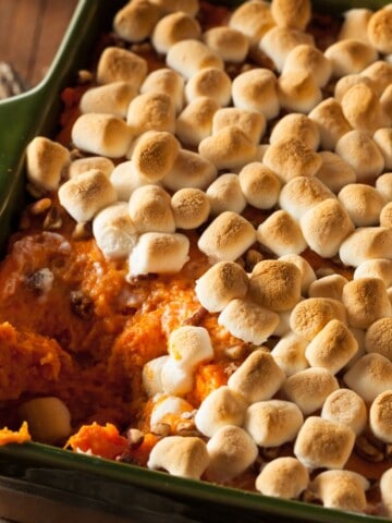 close up of sweet potato casserole with marshmallows and pecans.