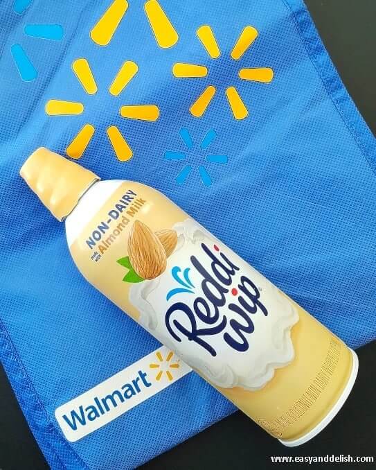 Non-dairy whipped topping can over a Walmart blue bag