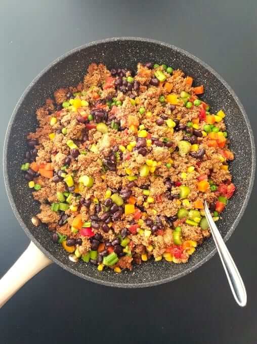 Mixing cooked ground turkey with sauteed vegetables for chili bean turkey pot pie